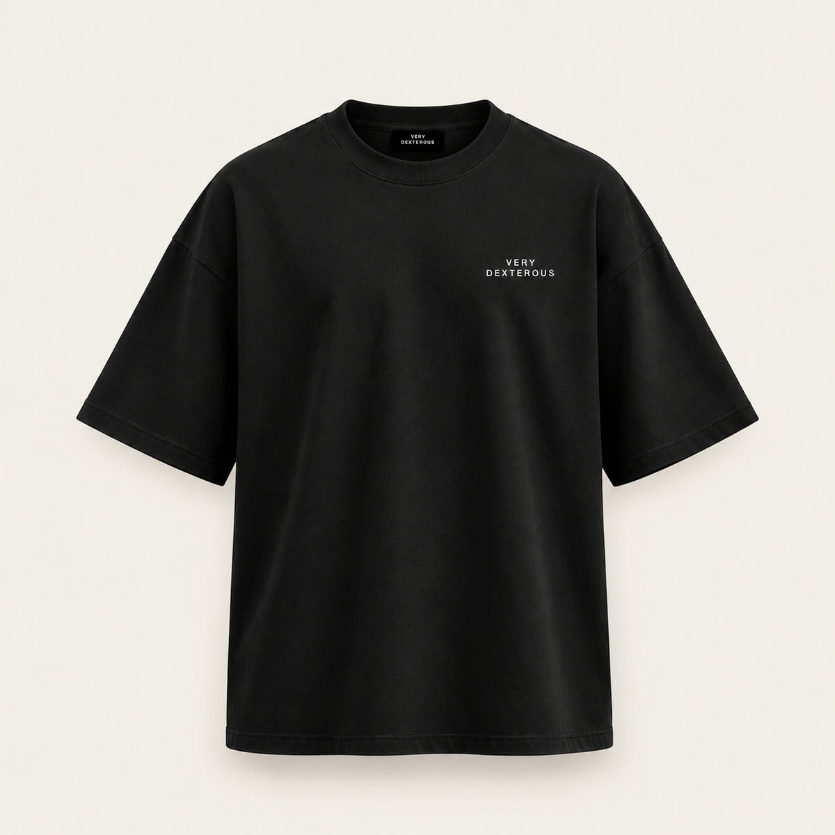 A Very Dexterous oversized black short-sleeve crewneck t-shirt with 'VERY DEXTEROUS' printed in small white text on the left chest, displayed against a light beige background.